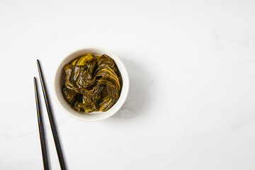 Top view of fermented bok choy served in a white bowl