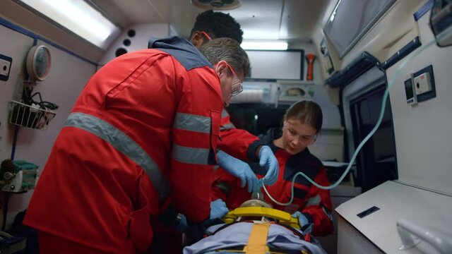 Ambulance doctors saving life of victim in ambulance vehicle