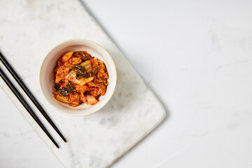 Top view of kimchi served in a white bowl
