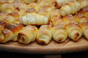 Baked rolls with sesame served on a wooden board