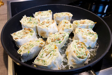 Snack roll of pita on a frying pan. close up