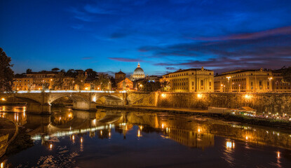 Sunset view at St. Peter's cathedral in Rome with its reflection on Tiber river