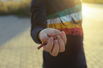 boy showing his hand full of firecrackers in valencian fallas festivals at the sunset