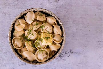 Boiled meat dumplings served with butter. Top view.