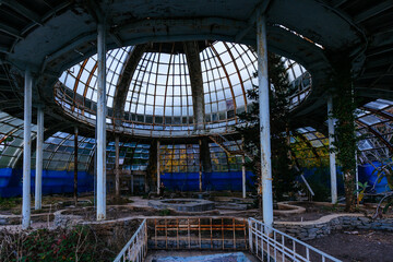 Dome of old abandoned greenhouse winter garden