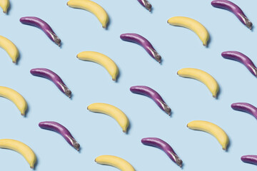 Japanese eggplant and banana isometric layout on a pastel blue background. Vegan ingredients minimal flat lay