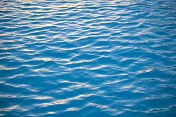 Closeup seascape surface of blue sea water with small ripple waves