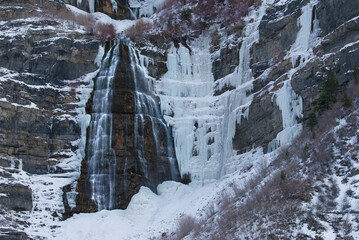 Fototapeta na wymiar waterfall in the mountains bridal veil falls in the winter ice and water frozen waterfall
