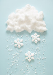 Snowflakes fall from the cloud. Winter New Year handmade concept. Flat lay background.