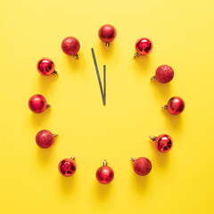 New Year clock with Christmas baubles. Minimal Christmas concept. Flat lay background. Creative idea.