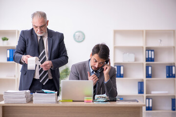 Two male bookkeepers in budget planning concept in the office