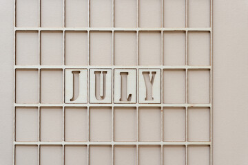 the month "july" in stencil font on paper