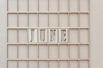 the month "june" in stencil font on paper
