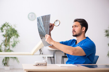 Young male doctor radiologist sitting in the clinic