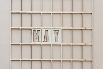 the month "may" in stencil font on paper