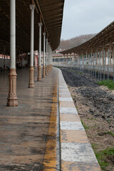 Obraz premium Empty train station in fall winter season. Vertical photo.