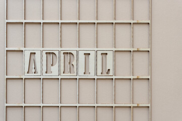 the month "april" in stencil font on paper