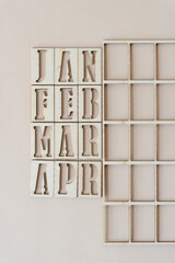 the months jan to apr in stencil font on paper