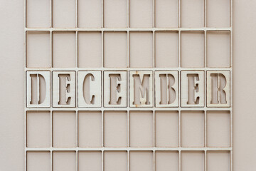 the month "december" in stencil font on paper