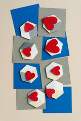 grungy red hearts on illusionistic cubes on blue and gray paper squares