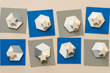 wooden stars on illusionistic cubes and paper squares