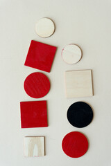 wooden shapes painted red or black on paper