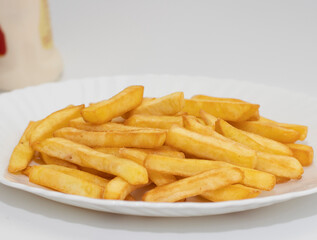 A plate with french fries, in blur container of mayonnaise and ketchup. Fast food concept.