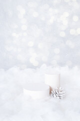 Podium or pedestal mock up for cosmetics in the snow with cone on bokeh background vertical format