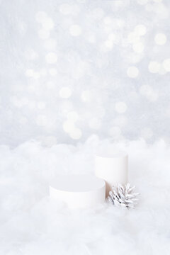 Podium or pedestal mock up for cosmetics in the snow with cone on bokeh background vertical format