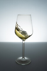 White wine swirling in to glass - stock photo