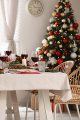 Festive dinner with delicious food and wine on table indoors. Christmas Eve celebration