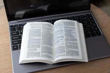 Bible and laptop on the work table. Bible Study Online