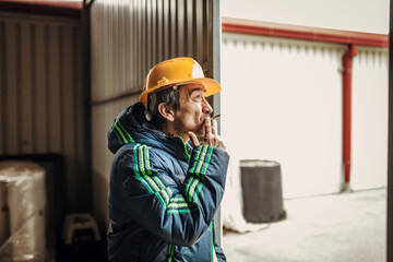 A worker smokes a cigarette during a break at work