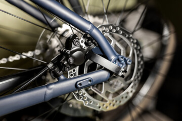 Fototapeta na wymiar Rear hydraulic disc brake rotor on new blue clip-on bicycle wheel, close-up