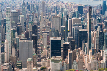 Fototapeta premium Aerial panoramic city view of Midtown Manhattan neighborhoods towards lower Manhattan, Central Park on bottom, New York City. Bird's eye view from helicopter of metropolis cityscape