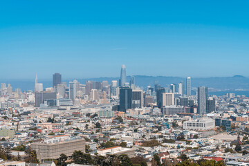 Fototapeta na wymiar Panoramic view of San Francisco skyline at daytime from hill side area. Financial District and residential neighborhoods, California, United States.