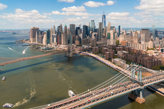 Aerial panoramic city view ofLower Manhattan area. Brooklyn and Manhattan bridges over East River, New York City, USA. Bird's eye view from helicopter of metropolis cityscape. A business neighborhood.