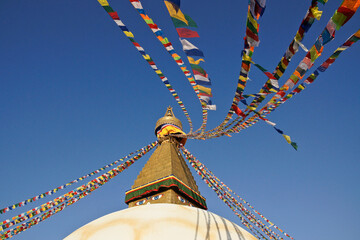 Boudhanath Tibetan Buddhist stupa with colorful prayer flags flying, Kathmandu, Nepal