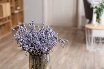 Vase with beautiful lavender flowers in room