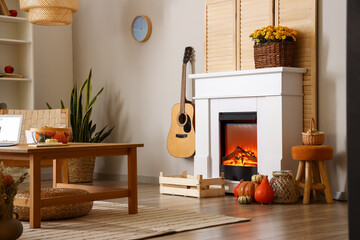 Interior of living room with autumn decor and fireplace