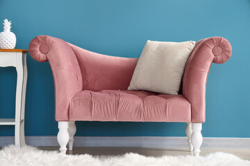 Stylish comfortable armchair near blue wall in room