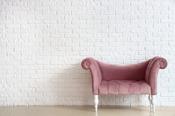 Stylish comfortable armchair near white brick wall in room