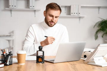 Male notary public working in office