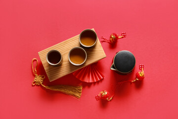 Traditional tea with Chinese symbols on red background