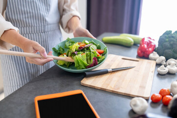 Woman cutting vegetables on a cutting board