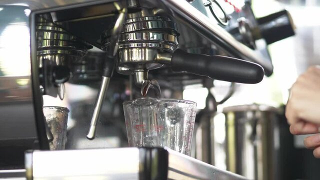 Slow Motion of coffee drop from espresso machine close up.