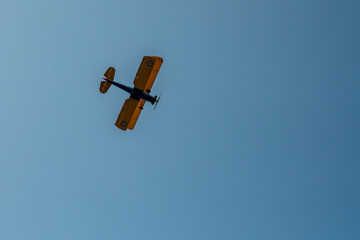 Biplane Files Over Head On Blue Sky