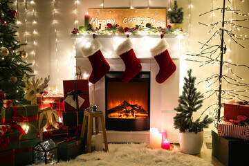 Interior of living room with Christmas tree and glowing garland at night