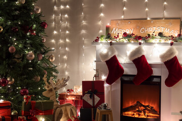 Interior of living room with Christmas tree, fireplace and glowing garland at night