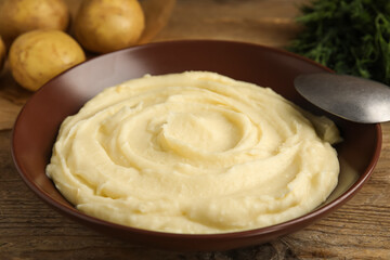 Freshly cooked homemade mashed potatoes on wooden table, closeup